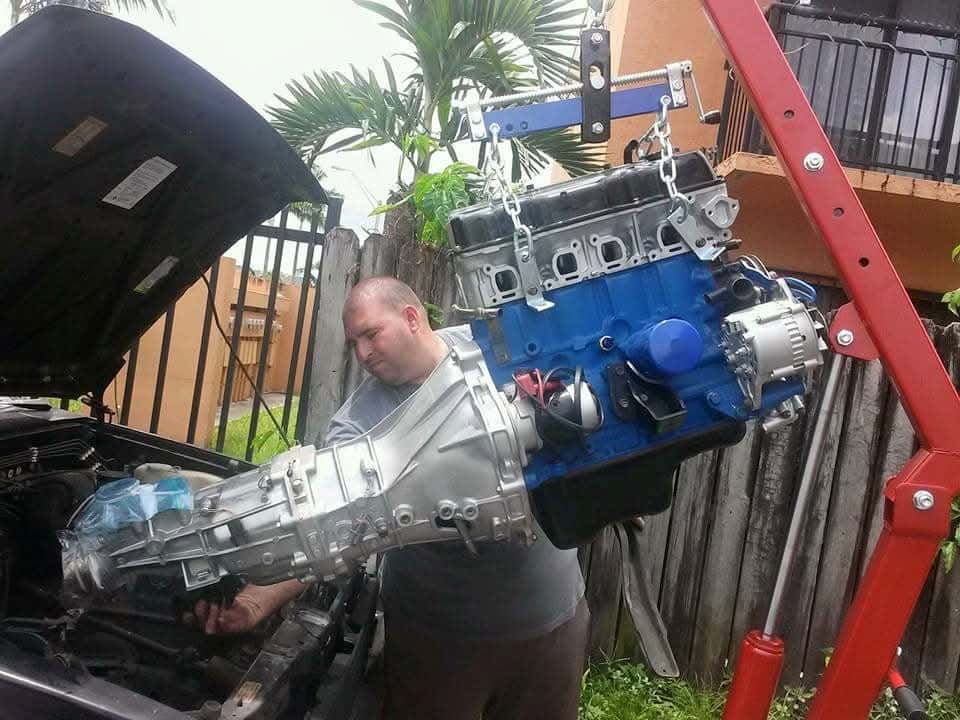 Pulling an engine on a hoist, long before the shop had a name