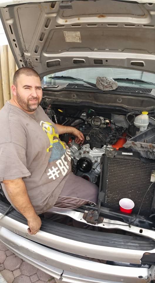 Working in the engine bay of a truck in the driveway